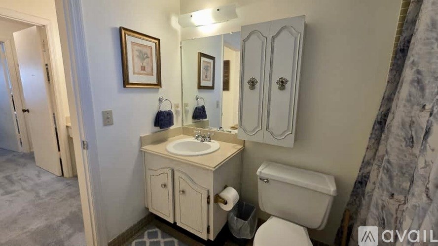 A bathroom with a sink, toilet, and medicine cabinet.