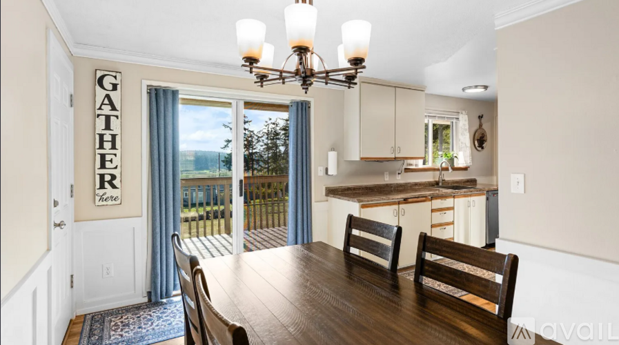 A dining room with a wooden table and chairs.