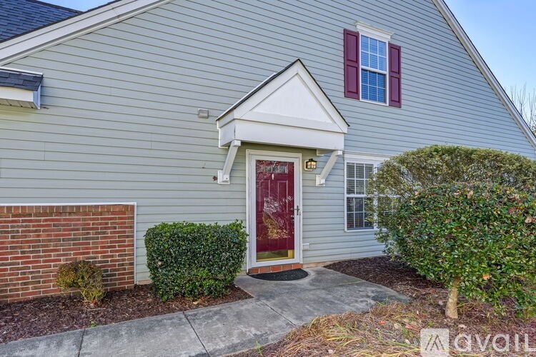 A house with a red door and a small window above it.