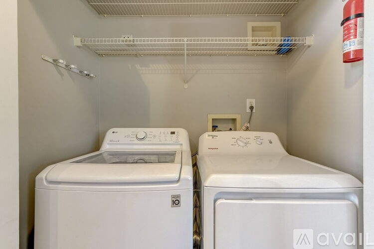 A small laundry room with a washer and dryer.