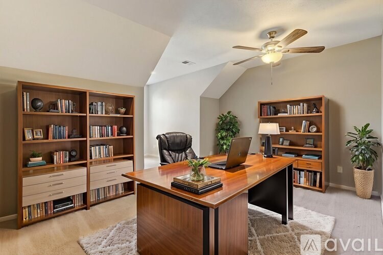 A room with a desk, a chair, and a bookshelf.