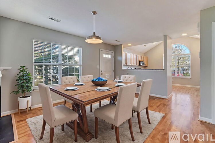 A dining room with a wooden table and chairs.