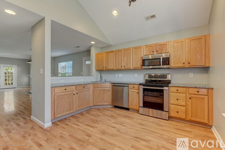A kitchen with wooden cabinets and stainless steel appliances.