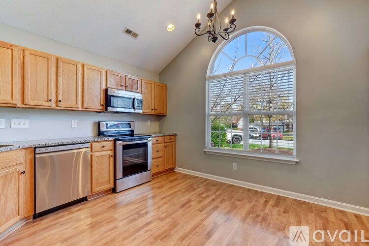 A kitchen with wooden cabinets and stainless steel appliances.