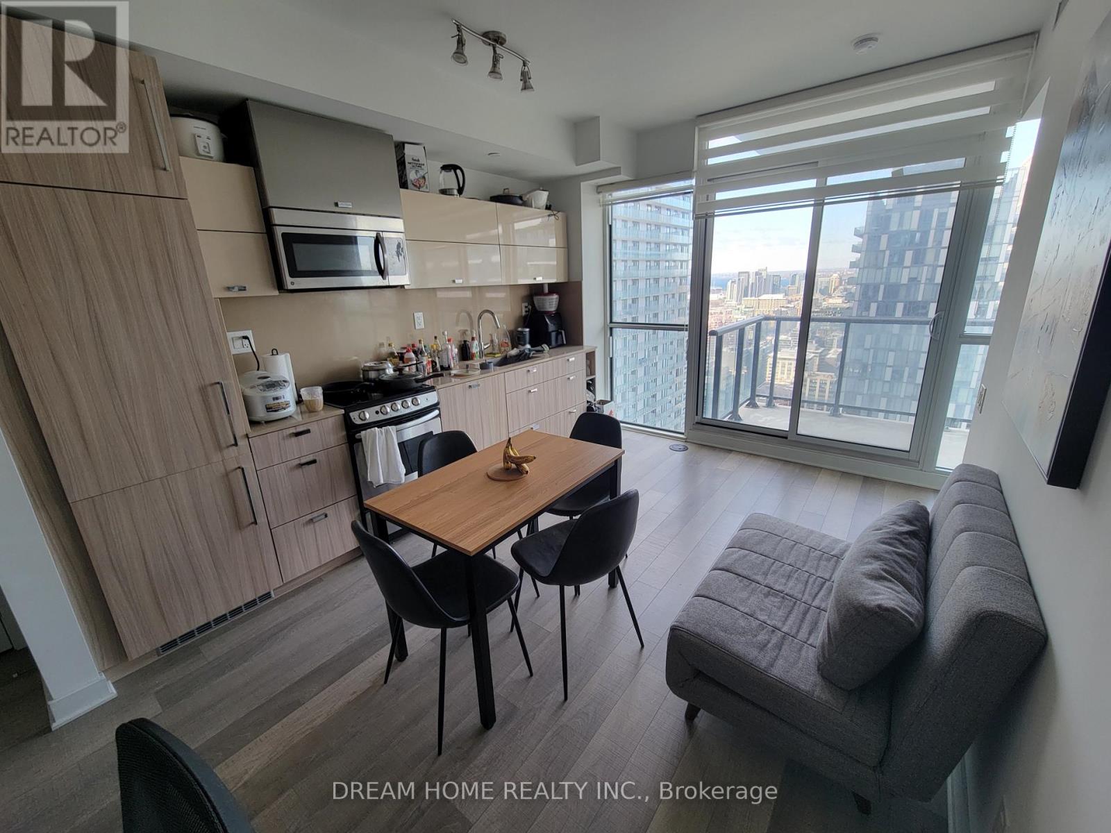 A kitchen with a table and chairs in front of a window.