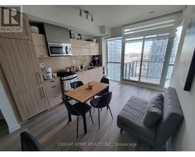 A kitchen with a table and chairs in front of a window.
