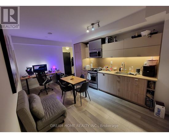 A modern kitchen and living room area with a dining table and chairs.