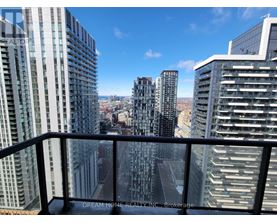 A cityscape with tall buildings and a clear sky.