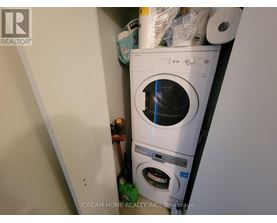 A white washing machine is in a small space with other items.