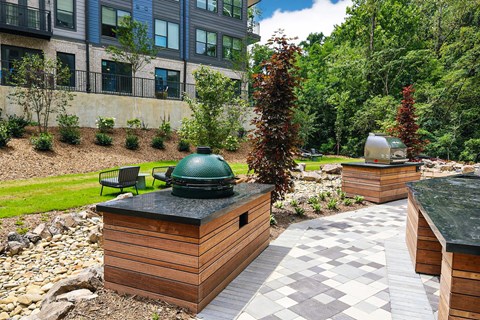 A backyard with a hot tub and a building in the background.
