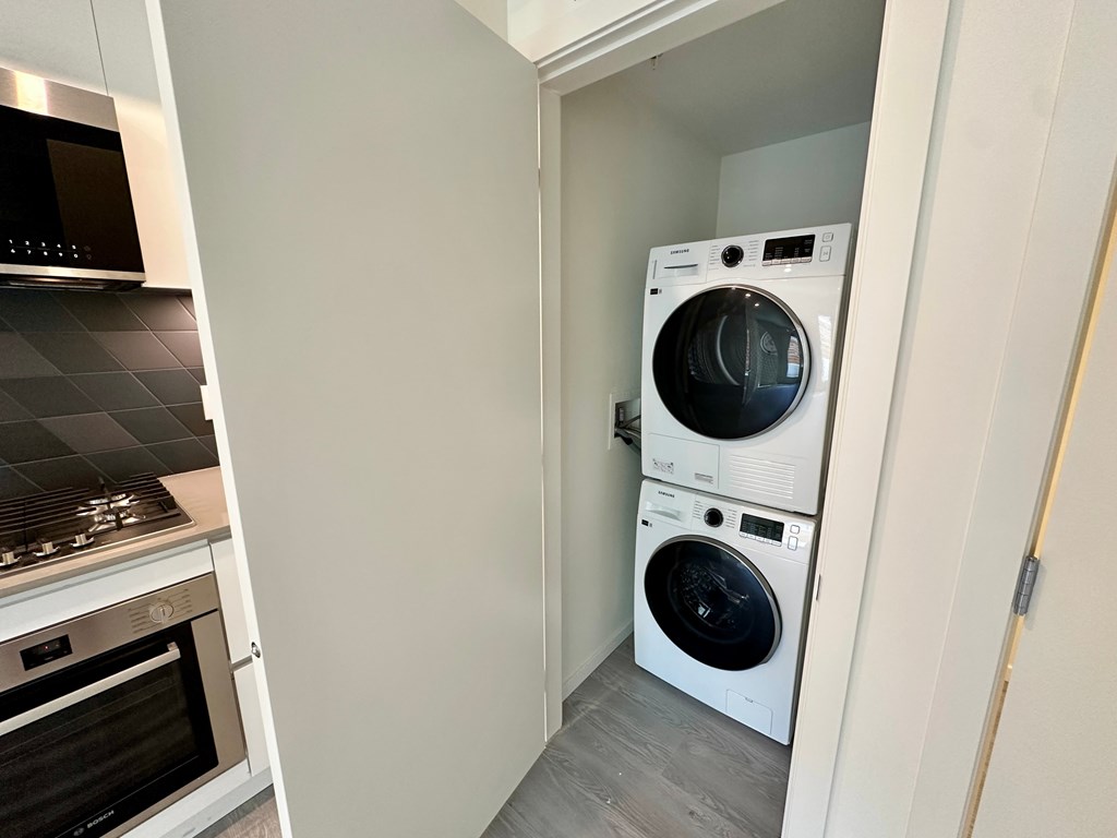 A white washing machine and dryer in a small laundry room.