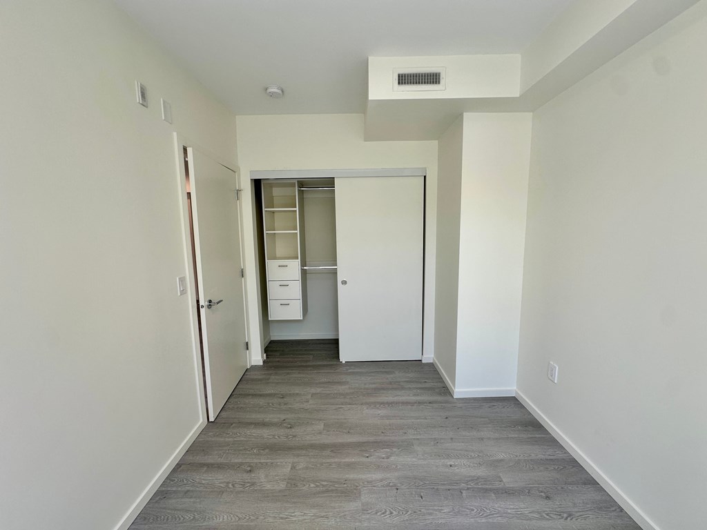 A long, narrow hallway with a door at the end.