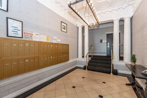 the lobby of a building with lockers and a staircase