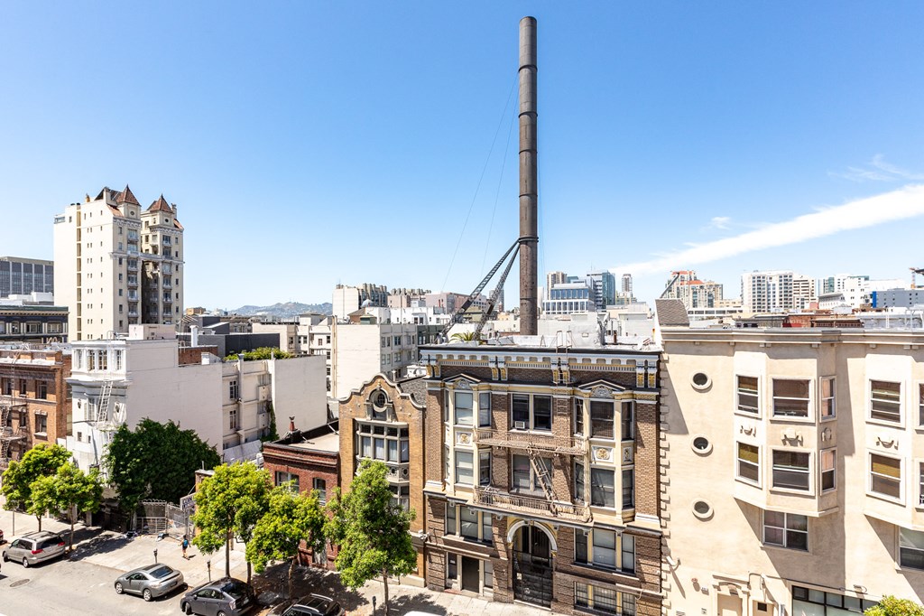 an aerial view of an old brick building with a smokestack on top