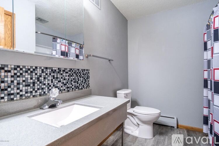 A bathroom with a white toilet and a sink.