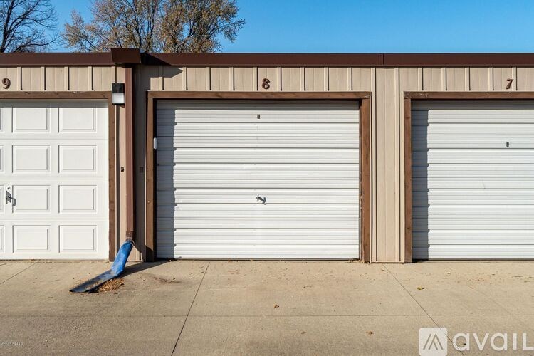 Three garage doors are closed, with the numbers 9, 8, and 7 on the wall above them.