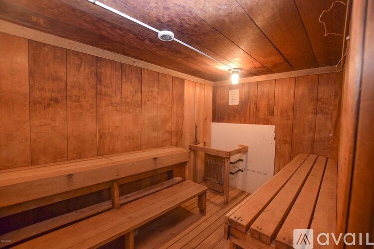 A sauna with wooden benches and a light on.