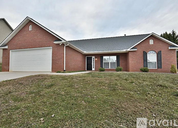 A house with a garage and a driveway.