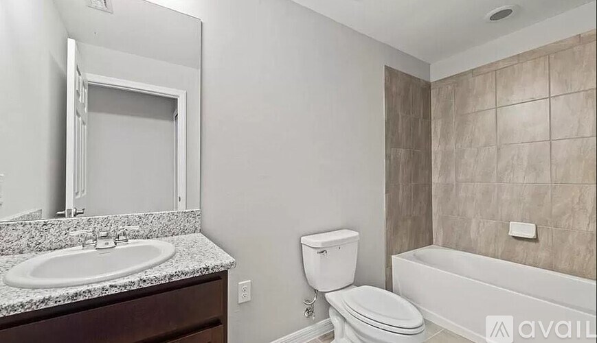 A bathroom with a toilet, sink, and bathtub.