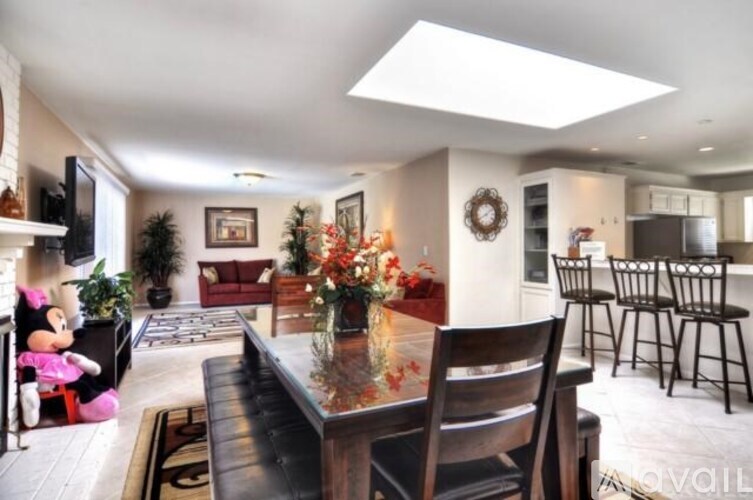 A living room with a black table and chairs.