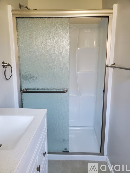 A frosted glass shower door in a bathroom.