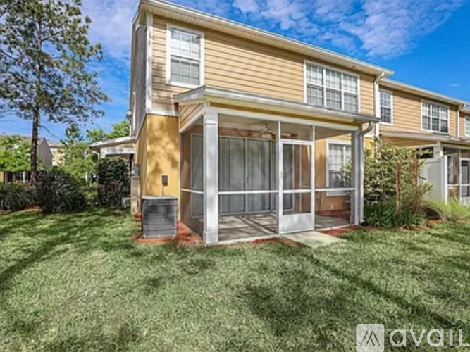 A two-story house with a balcony and a small garden in front.
