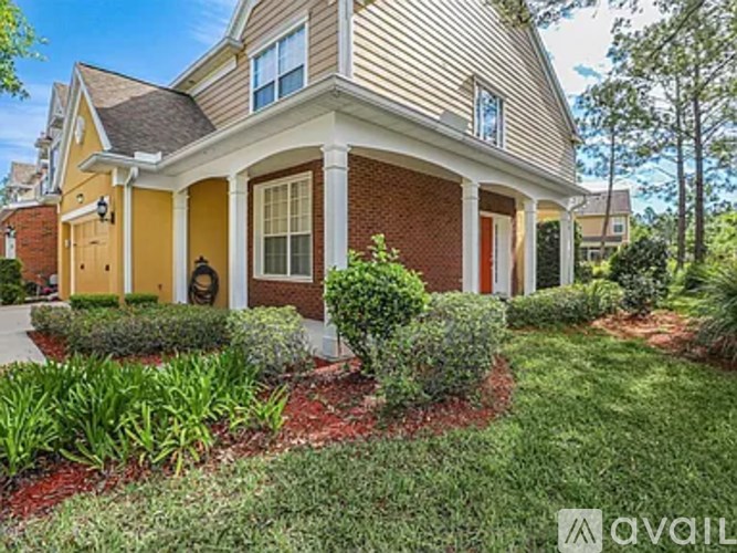 A house with a red brick facade and a yellow door.