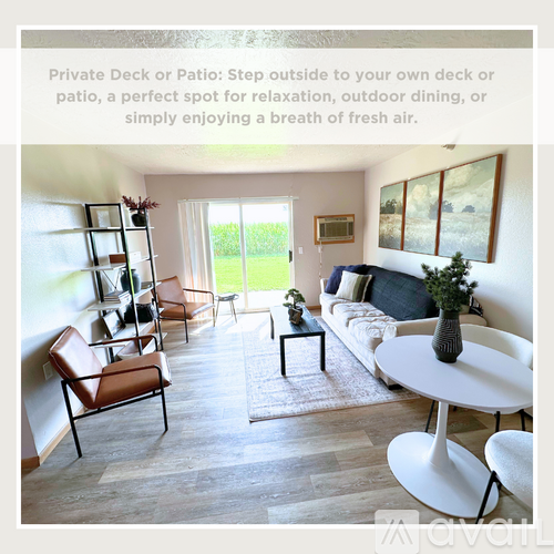 A living room with a white sofa, a white coffee table, and a white dining table.