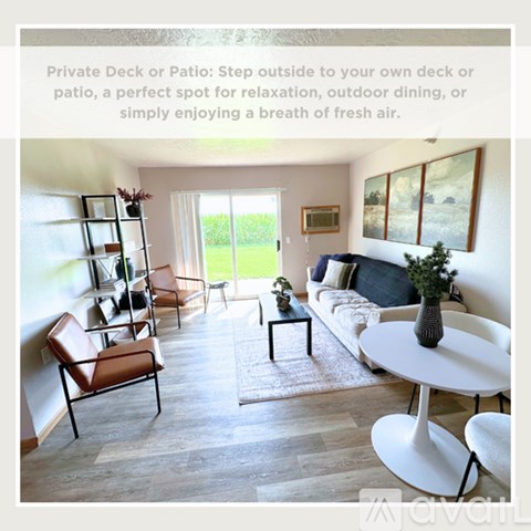 A living room with a white sofa, a white coffee table, and a white dining table.