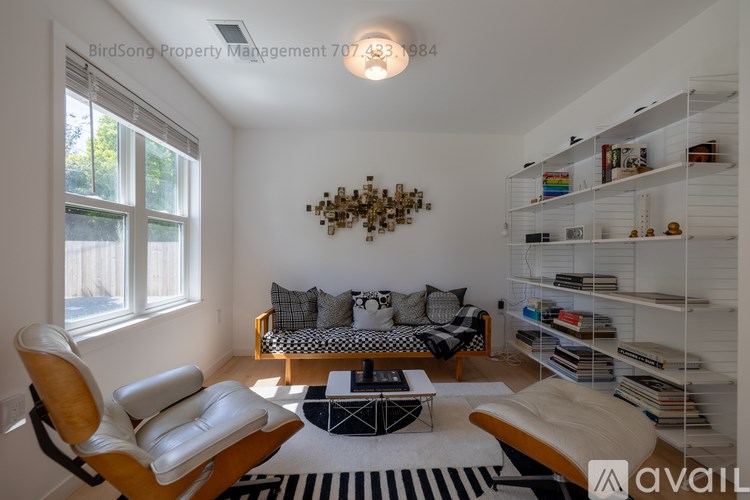 A living room with a sofa, a chair, and a coffee table.