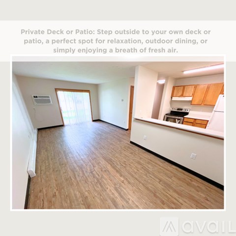 A private deck or patio area with wooden flooring and a window.