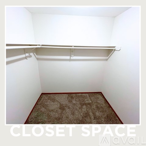 A small closet with a carpeted floor and a sign that says "CLOSET SPACE".