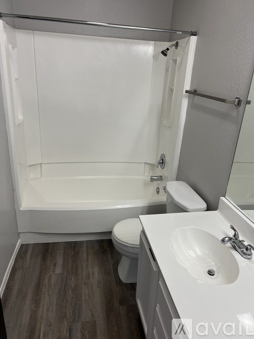 A bathroom with a toilet, sink, and bathtub.