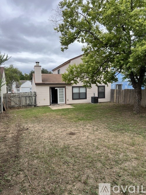 A house with a tree in front of it.