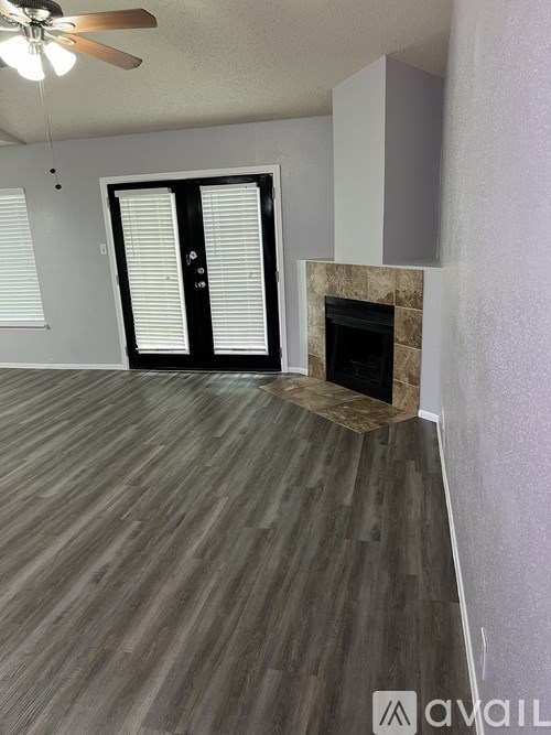 A room with a fireplace and a ceiling fan.