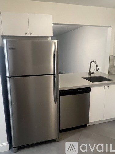 A stainless steel refrigerator and dishwasher in a kitchen.