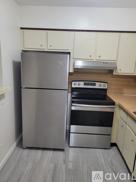 A kitchen with a stainless steel refrigerator and oven.