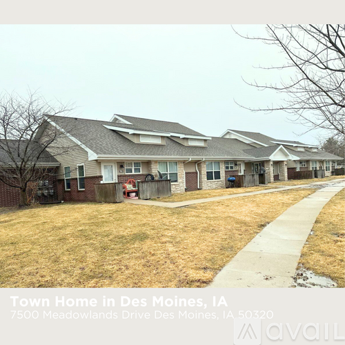 A townhouse in Des Moines, Iowa with a driveway and a sidewalk.