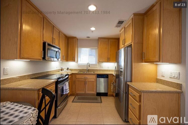 A kitchen with wooden cabinets and a black stove top oven.