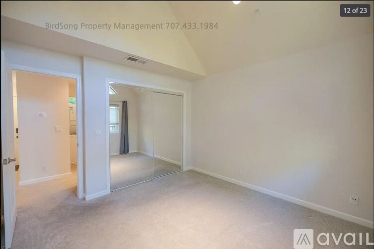 A room with white walls and carpeted floor is available for rent.