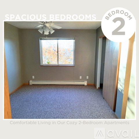 A spacious bedroom with a carpeted floor and a ceiling fan.