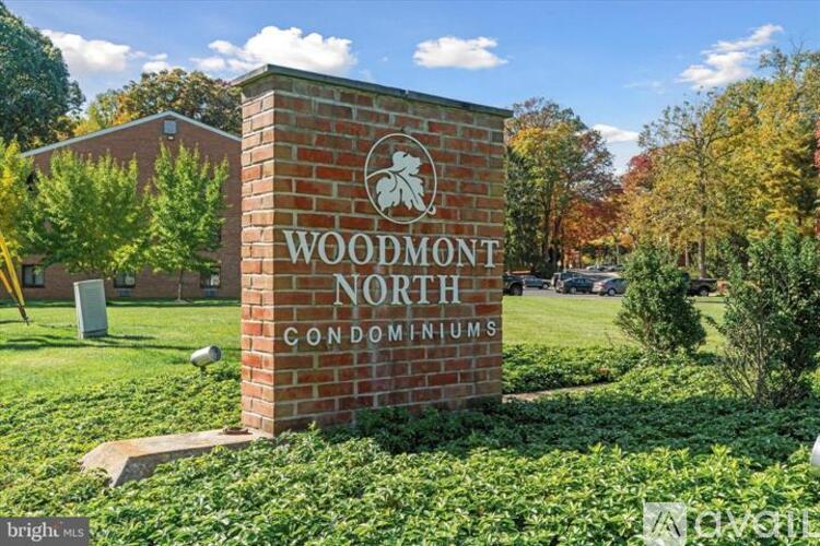 A brick sign that says Woodmont North Condominiums.