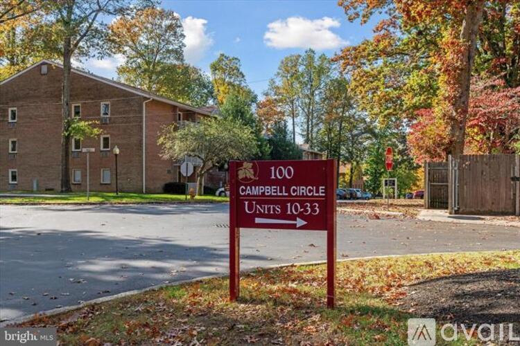 A sign in front of a building that says "Campbell Circle Units 10-33".