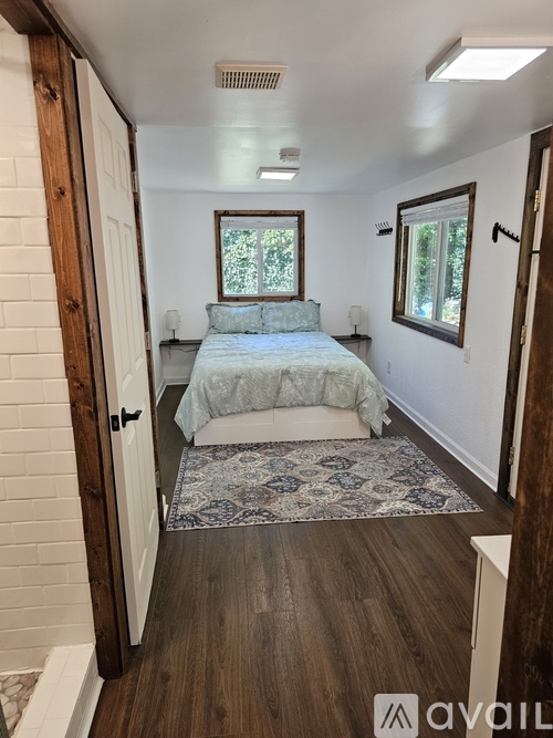 A bedroom with a bed and a window.