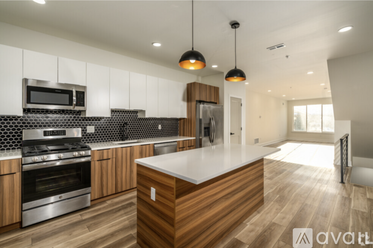 A modern kitchen with wooden cabinets and a central island.