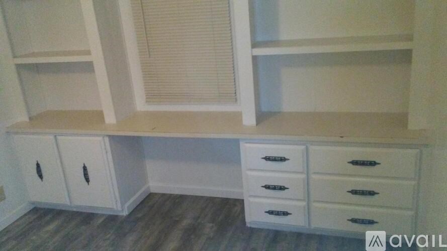 A white cabinet with drawers and shelves is available for purchase.