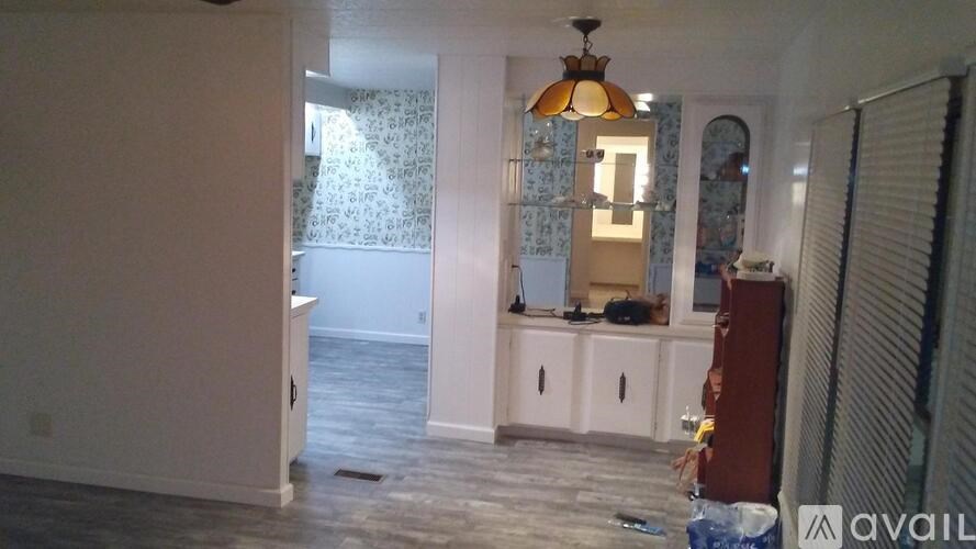 A room with a white cabinet and a hanging lamp.