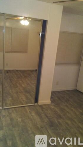 A room with a wooden floor and a glass door.