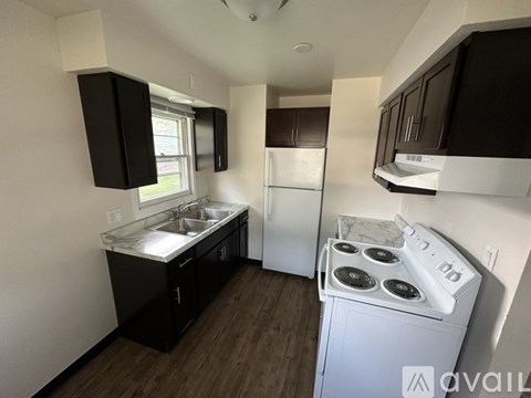 A small kitchen with a white stove top oven.