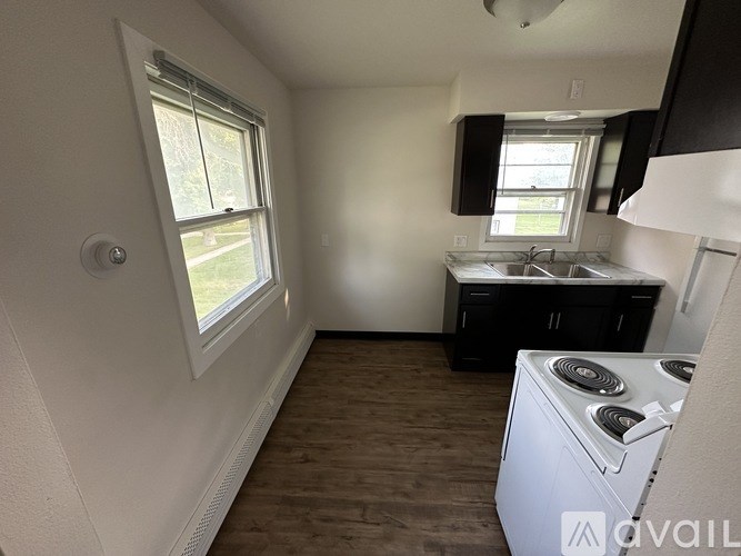A small kitchen with a stove and a window.